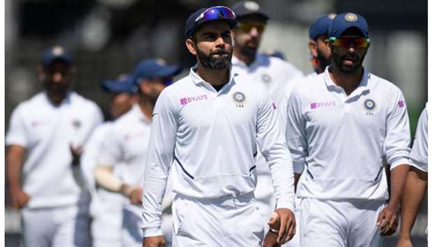 In this February 24, 2020, picture, Indiau2019s captain Virat Kohli (centre) walks off the field with his team after losing the match to New Zealand on Day Four of the first Test in Wellington, New Zealand. (AFP)
