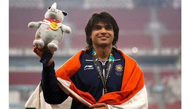 Gold medallist Neeraj Chopra of India celebrates on the javelin throw podium of the 2018 Asian Games at the GBK Main Stadium in Jakarta on August 27, 2018. (Reuters)