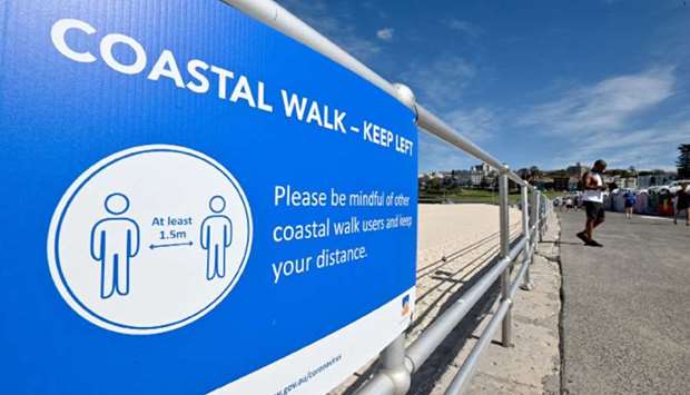 A social distancing sign hangs on the railing of Bondi Beach as it remains closed due to restrictions in place to help stop the spread of the coronavirus in Sydney yesterday.