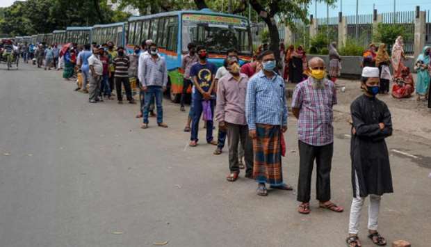 People queue to collect subsidised food items during a government-imposed nationwide lockdown as a preventive measure against coronavirus (Covid-19), in Dhaka yesterday.