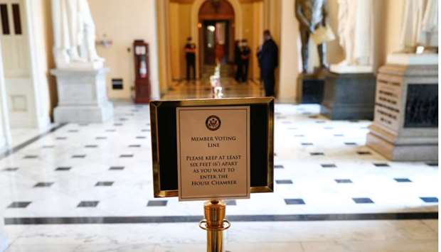 A sign indicating proper social distancing measures is displayed ahead of a vote later in the day in the House of Representatives on an additional coronavirus economic stimulus package passed earlier in the week by the US Senate.