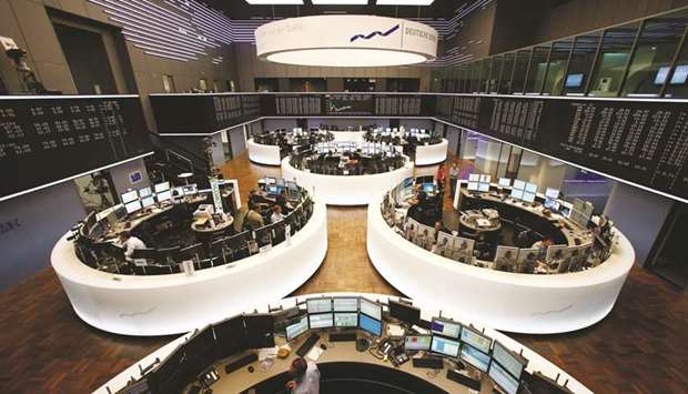 Traders work at the Frankfurt Stock Exchange. The DAX 30 closed down 1.7% to 10,336.09 points yesterday.
