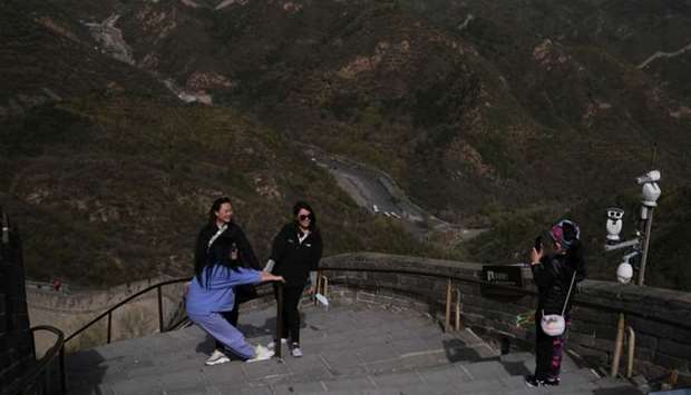 Visitors pose for pictures, following the coronavirus disease (Covid-19) outbreak, at the Badaling section of the Great Wall in Beijing, China