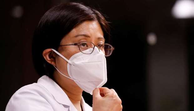 Fumie Sakamoto, a nurse of St. Luke's International Hospital, adjusts her mask during an interview with Reuters at the hospital in Tokyo, Japan April 21