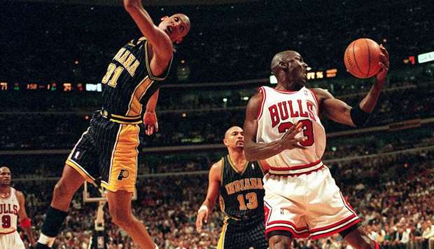 Chicago Bullsu2019 Michael Jordan (right) keeps the ball from Indiana Pacersu2019 Reggie Miller during the first quarter of a playoff game at the United Center in Chicago on May 19, 1998. (TNS)