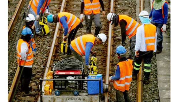 Metro Rail Transit 3 personnel start work on the tracks along Quezon City, after the Department of Transportation, through the Inter-Agency Task Force for the Management of Emerging Infectious Diseases, approved the resumption of its railroad projects.