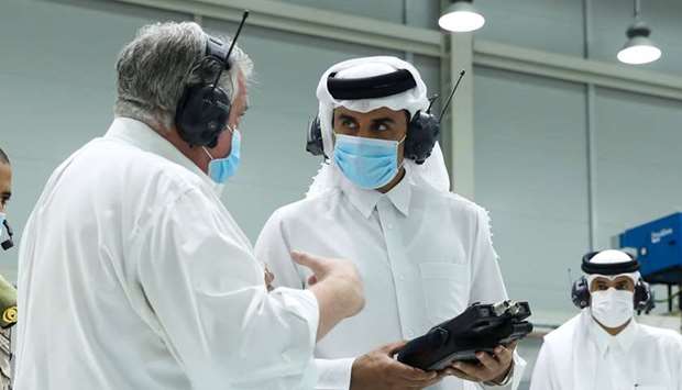 His Highness the Amir Sheikh Tamim bin Hamad al-Thani listening to an explanation about the production lines of the (Savr-Q) respirator during his visit to the Research and Development Center at Barzan Holdings