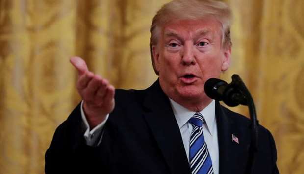 US President Donald Trump takes a question as he addresses an East Room event highlighting Paycheck Protection Program (PPP) loans for small businesses adversely affected by the coronavirus disease outbreak, at the White House in Washington