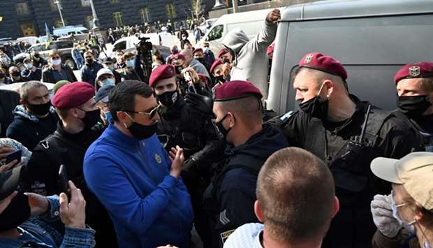 Protesters argue with riot police during the demonstration in downtown Kyiv.