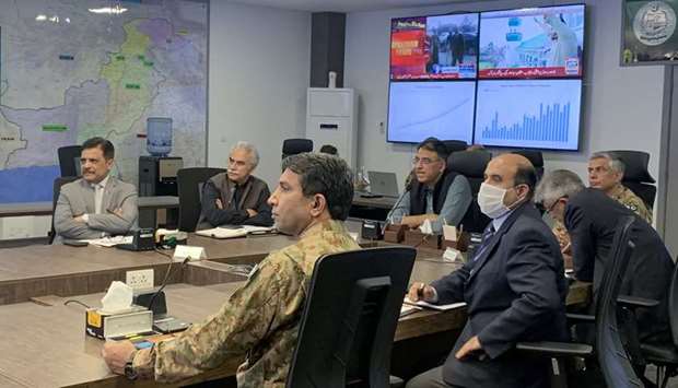 Planning Minister Asad Umar, along with health officials, address a briefing at the National Command and Control Centre in Islamabad on the spread of the coronavirus disease.