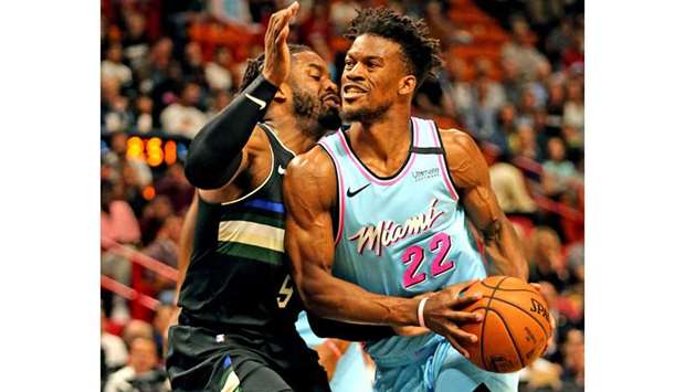 The Miami Heatu2019s Jimmy Butler (right) drives against the Milwaukee Bucksu2019 Wesley Matthews at the AmericanAirlines Arena on March 2, 2020. (TNS) a