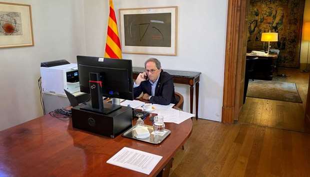 Spain's Catalonia regional head of government Quim Torra talks on his mobile phone during an interview with Reuters from his government palace in Barcelona
