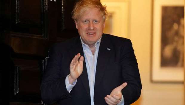 Britain's Prime Minister Boris Johnson applauds in support of the NHS during Clap for our Carers, outside 11 Downing Street in London