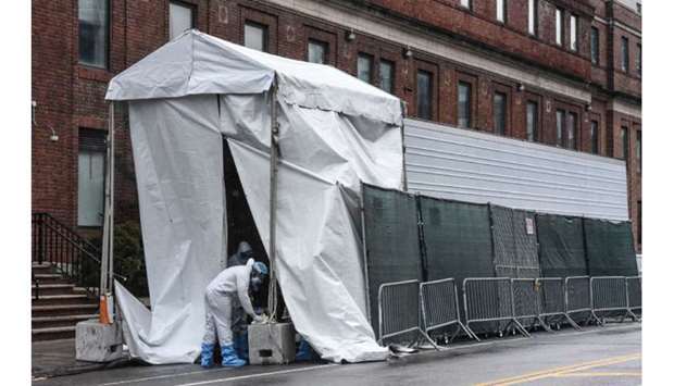 Medical workers are seen at a temporary morgue outside of Brooklyn Hospital Centre in New York City.