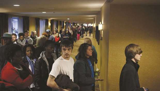 People wait in line to enter a job fair in Louisville, Kentucky. The Labour Departmentu2019s closely watched employment report on Friday did not fully reflect the economic carnage being inflicted by the highly contagious virus.