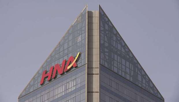 Signage for HNA Group is displayed atop the companyu2019s building in Beijing. The company appointed Houlihan Lokey as financial adviser as it considers a restructuring of its u20ac1.6bn ($1.7bn) of debt, people familiar with the matter said.