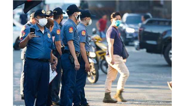 Police monitor a street in Quezon city.