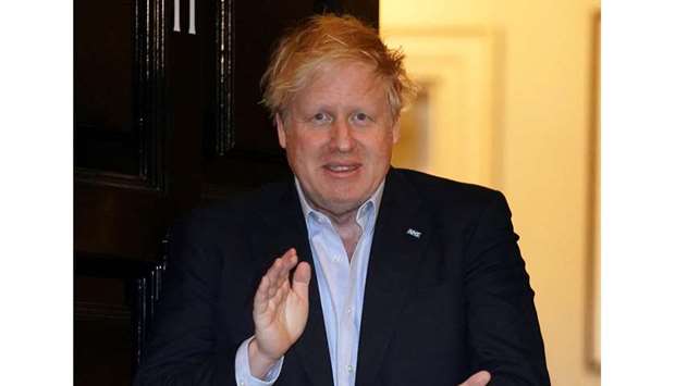 Prime Minister Boris Johnson applauds in support of the NHS during Clap for our Carers, outside 11 Downing Street in London.