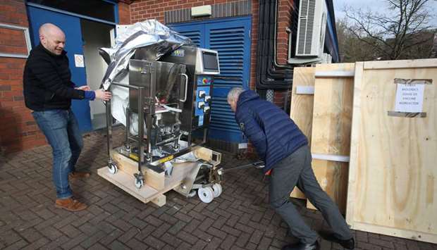 Engineers outside Cobra Biologics, arrive with a bioreactor in the hope of developing a vaccine against Covid-19 as the spread of the coronavirus disease continues, Keele, Britain, yesterday.