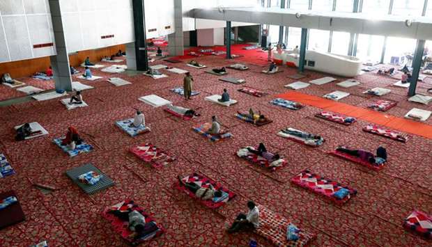 Migrant workers and homeless people rest inside a sports complex turned into a shelter, during a 21-day nationwide lockdown to slow the spread of the coronavirus disease (Covid-19), in New Delhi, India