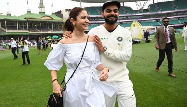 In this file photo taken on January 07, 2019, Virat Kolhi and his wife Anushka Sharma walking on the field as they celebrate Indiau2019s Test series win against Australia at the Sydney Cricket Ground in Sydney. (AFP)