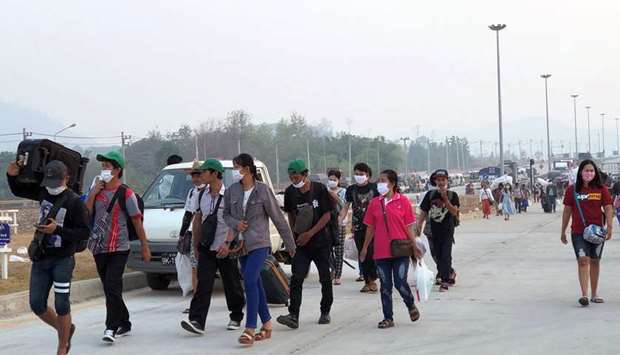 Migrant workers from Myanmar are seen on the border as they try to go back their home country due to coronavirus disease (Covid-19) outbreak, at Mae Sot, Thailand in this March 25 picture.