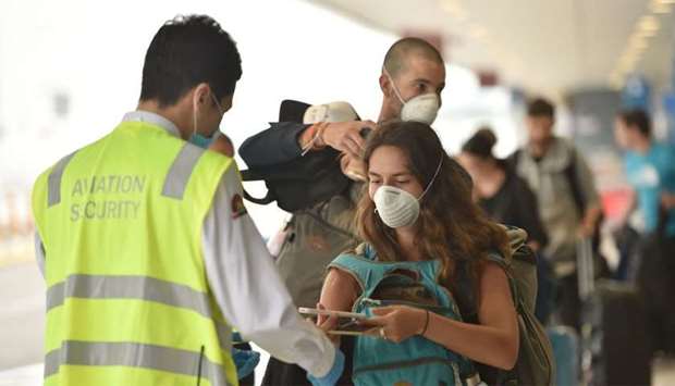 French nationals queue to enter Sydney's international airport to be repatriated back to France amid the COVID-19 coronavirus pandemic.