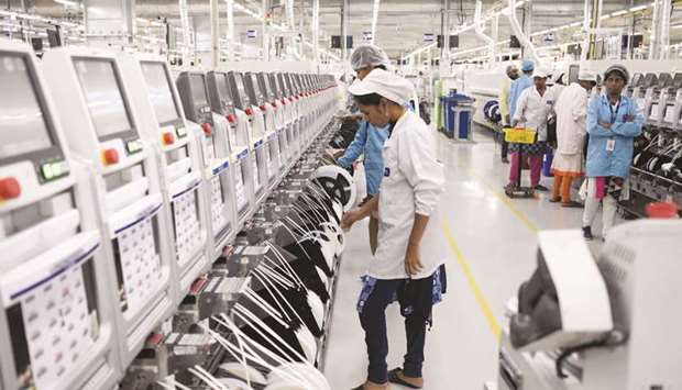 Employees work on an assembly line in the mobile phone plant of Rising Stars Mobile India Pvt, a unit of Foxconn Technology Co, in Sriperumbudur, Tamil Nadu. Foxconn said in a statement it was intended to communicate its thoughts on the latest developments affecting the consumer electronics industry and not focused on any specific products or customer.