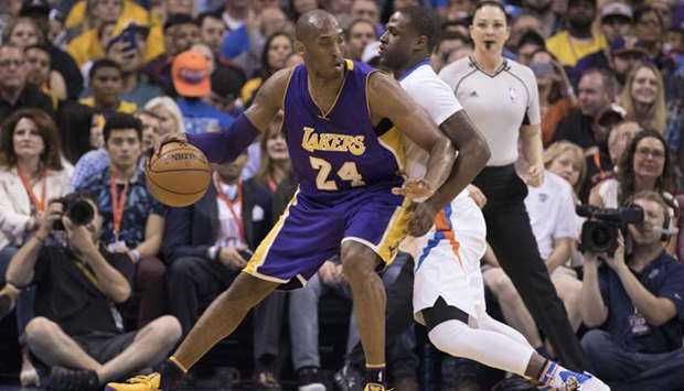 In this file photo taken on April 11, 2016, Kobe Bryant #24 of the Los Angeles Lakers tries to drive around Dion Waiters #3 of the Oklahoma City Thunder during the second quarter of a NBA game at the Chesapeake Energy Arena in Oklahoma City, Oklahoma.