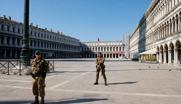 Soldiers patrol an empty Saint Mark's Square on Palm Sunday, following the coronavirus disease (Covid-19) outbreak in Venice, Italy
