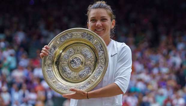 In this July 13, 2019 picture, Simona Halep poses with the winneru2019s trophy after winning at Wimbledon. (USA TODAY Sports)
