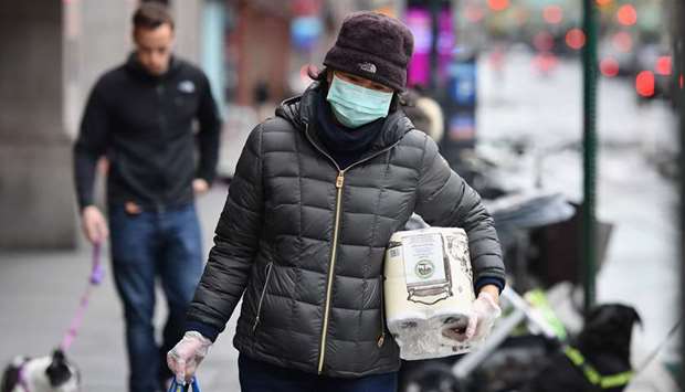People wear face masks in New York on Friday.