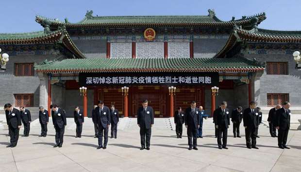 President Xi Jinping, Li Keqiang, Li Zhanshu, Wang Yang, Wang Huning, Zhao Leji, Han Zheng and Wang Qishan, as well as other party and state leaders, stand in silence during the national mourning for martyrs who died fighting the novel coronavirus disease (Covid-19) and compatriots who lost their lives in the outbreak, at the Zhongnanhai leadership compound in Beijing yesterday.