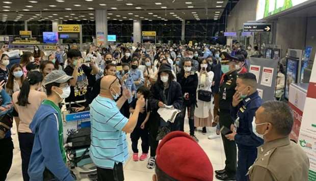 Thai passengers talking with immigration authorities at Suvarnabhumi Airport in Bangkok, as they refused to go into state quarantine facilities amid the Covid-19 coronavirus outbreak, according to officials.