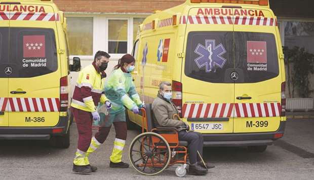Paramedics wheel a patient from an ambulance into the emergency department of the 12 de Octubre hospital in Madrid.