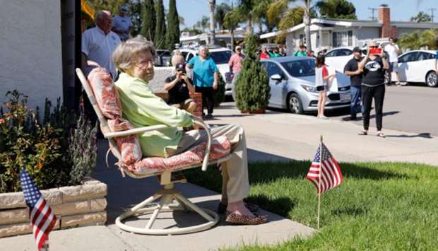 Well-wishers and friends gather on the street outside the home of former US Marine nurse Ruth Gallivan to help celebrate her 104th birthday during the outbreak of the coronavirus disease in San Diego, California on April 1, 2020, in the photo released by Reuters yesterday.