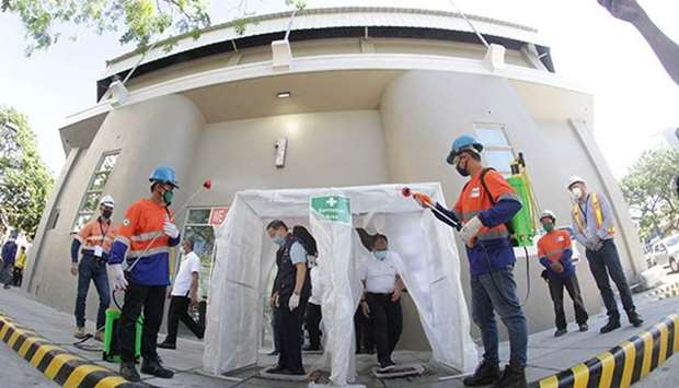 Government officials inspect a disinfection booth at the Ninoy Aquino Stadium, one of the quarantine facilities for coronavirus disease 2019 (Covid-19) patients, inside the Rizal Memorial Sports Complex in Malate, Manila.