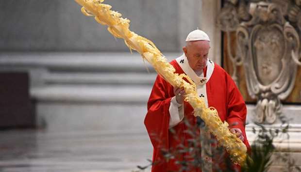 Pope Francis gathers his thoughts while holding a palm branch as he celebrates Palm Sunday mass behind closed doors at St Peteru2019s Basilica.
