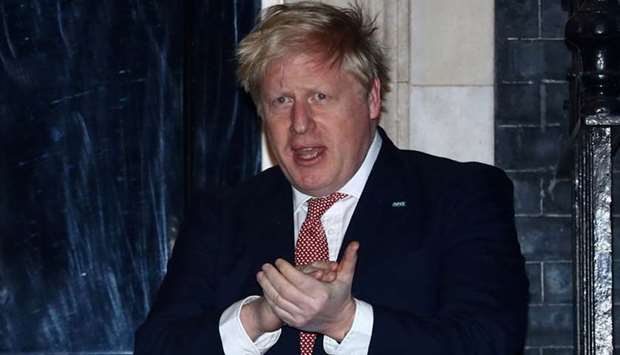 Britain's Prime Minister Boris Johnson applauds outside 10 Downing Street during the Clap For Our Carers campaign in support of the NHS, as the spread of the coronavirus disease (Covid-19) continues, London on March 26. Reuters