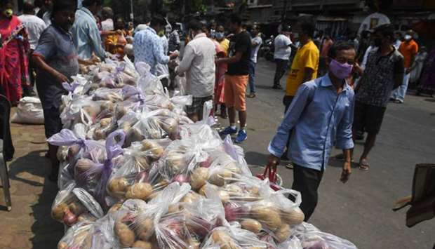 People collect grocery items at a distribution centre organised by local clubs in Kolkata yesterday.