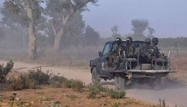 Members of the Cameroonian Rapid Intervention Force patrol the outskirts of Mosogo