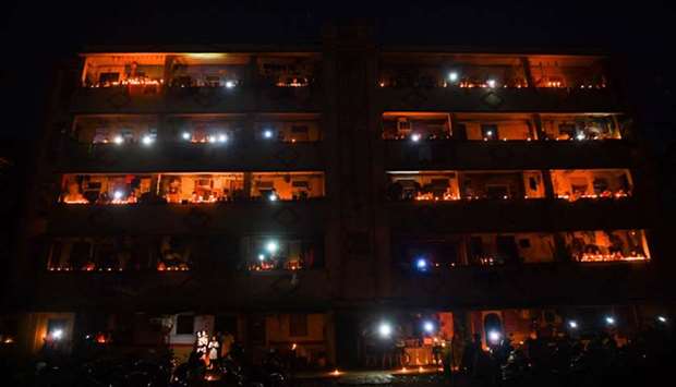 Residents light candles and turn on their mobile phone lights in their balcony to observe a nine-minute vigil called by Prime Minister Narendra Modi in a show of unity and solidarity in the fight against the coronavirus pandemic, in Mumbai yesterday.