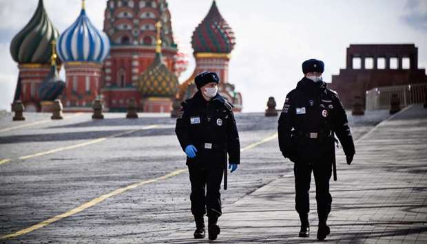 Police officers patrol a deserted Red Square in Moscow yesterday.