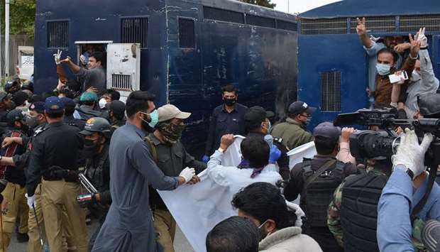 Policemen arrest doctors and paramedics in the course of a protest during a government-imposed nationwide lockdown as a preventive measure against the Covid-19 coronavirus, in Quetta yesterday.