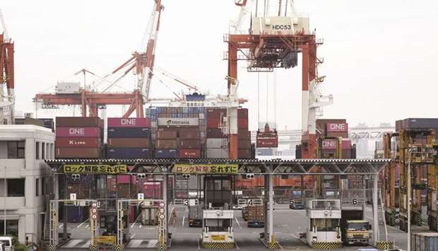A gantry crane lifts a Kawasaki Kisen Kaisha u201cKu201d Line container at a shipping terminal in Yokohama, Kanagawa Prefecture. Consumer sentiment in Japan is at its lowest since the aftermath of the collapse of Lehman Brothers as the virus starts cutting income and jobs.