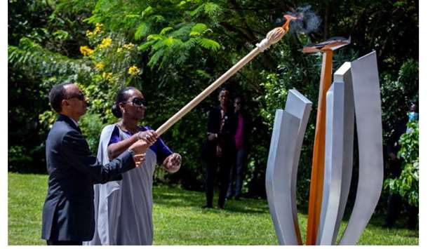 President Paul Kagame and First Lady Jeanette Kagame light the genocide flame of hope, known as the Kwibuka (Remembering), to commemorate the 1994 genocide at the Kigali Genocide Memorial Center in Kigali.