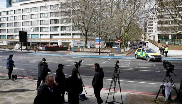 Members of the news media gather outside St Thomas' Hospital in London