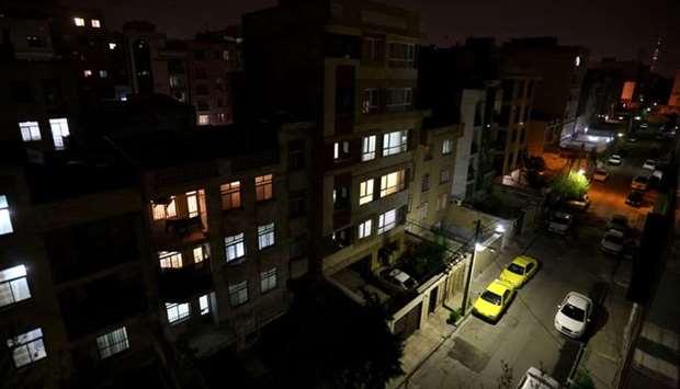 Windows of residential buildings are lit at nighttime as people stay at home during the Covid-19 coronavirus outbreak, in the Iranian capital Tehran, yesterday.