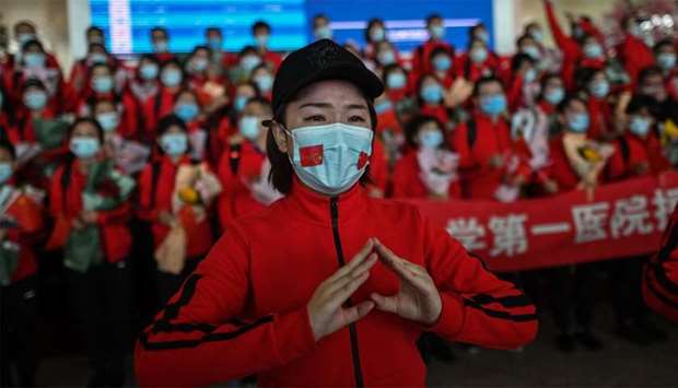 A medical staff member from Jilin Province tears up during a ceremony before leaving as Tianhe Airport is reopened in Wuhan in China's central Hubei province