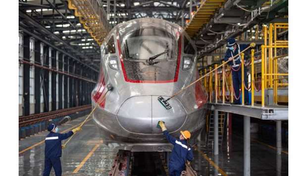 Staff members cleaning a bullet train in preparation for resuming operations after authorities lifted a more than two-month ban on outbound travel, in Wuhan in Chinau2019s central Hubei province.